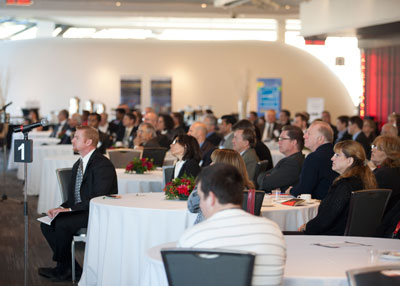 Audience listens to Minister Knubley's opening remarks.