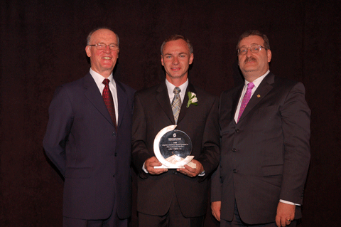 Eric Esselink receives the Corporate Commitment award from Hugh Krentz and Rae Dulmage