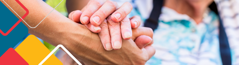 Female doctor giving encouragement to elderly patient by holding her hands
