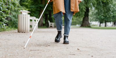 Person in Brown Coat and Blue Denim Jeans Walking