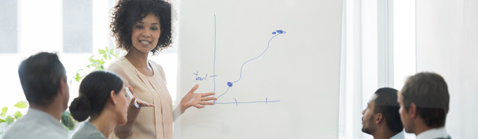 Woman in front of a line graph