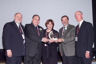 Peter Clark et Hugh Krentz présentent le prix de dévouement décerné aux entreprises à Gilles Béland, Jocelyne Fortin et Jacques Régis 