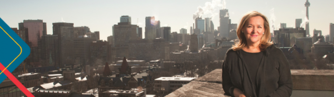 Dr Patricia McCarney in front of the Toronto city skyline 