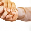 Doctor holding senior patients hand