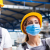 Two warehouse workers with PPE